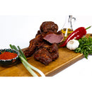 Smoked homemade sheep pastrami from DELUMANI, sliced and ready to serve, showing its rich texture and marbling.